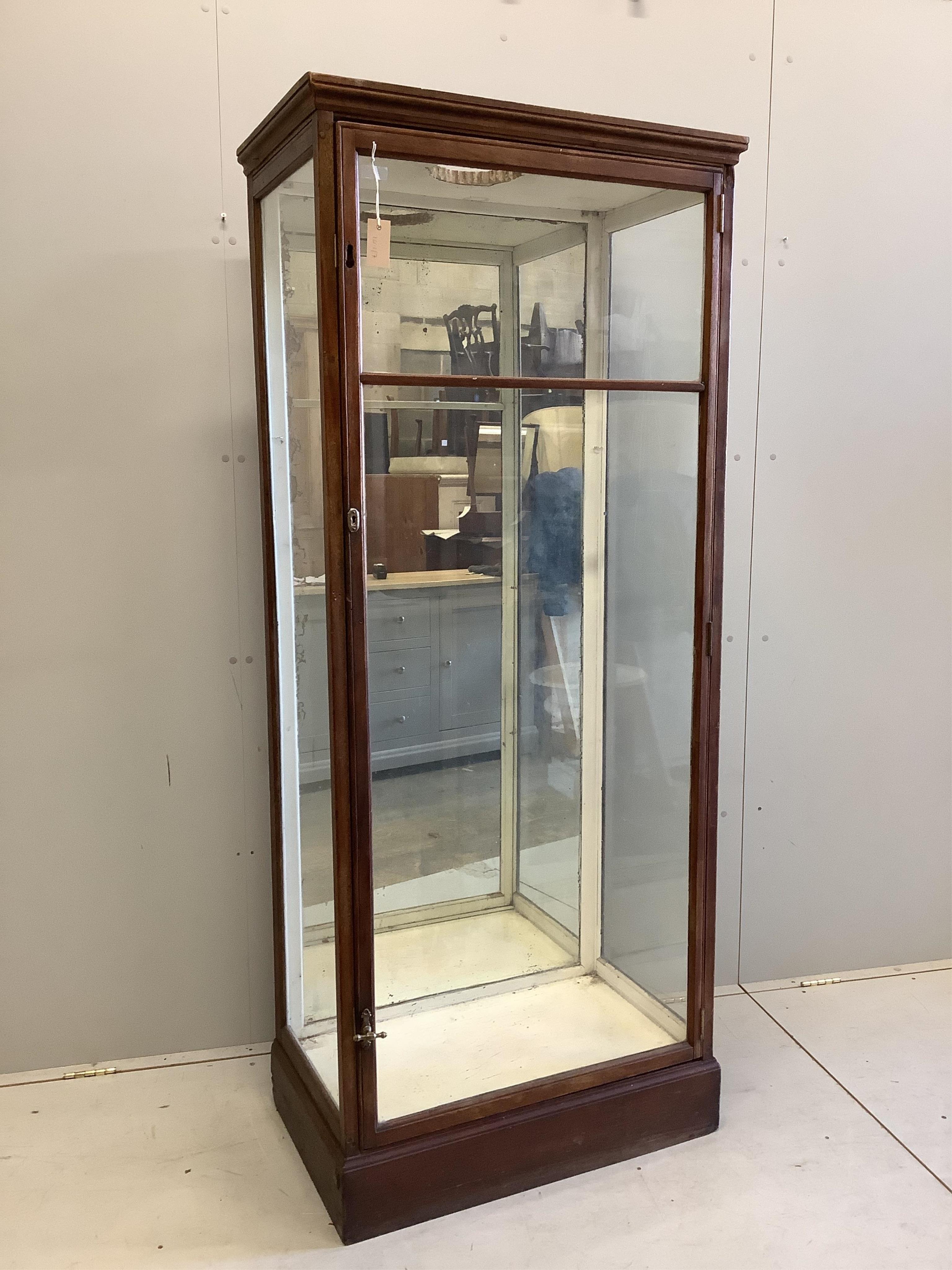 An early 20th century mirrored oak shop display cabinet, width 80cm, depth 47cm, height 189cm. Condition - poor, top has been cut to accommodate a light, lacks glass shelving